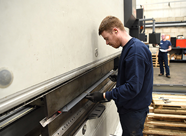 Press brake operator working on a machine